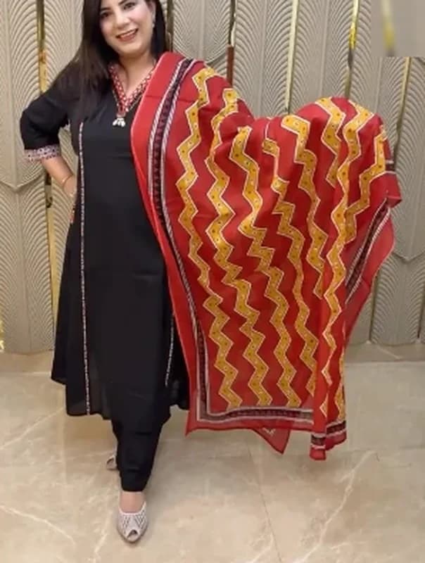 Black kurta set with a red and mustard zigzag dupatta