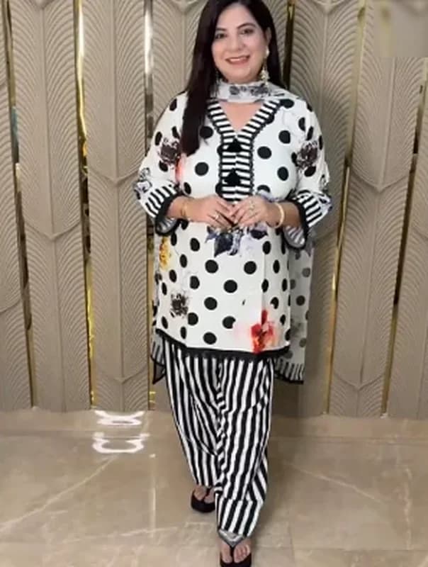 Black and white polka dot kurta with striped pants and a printed dupatta